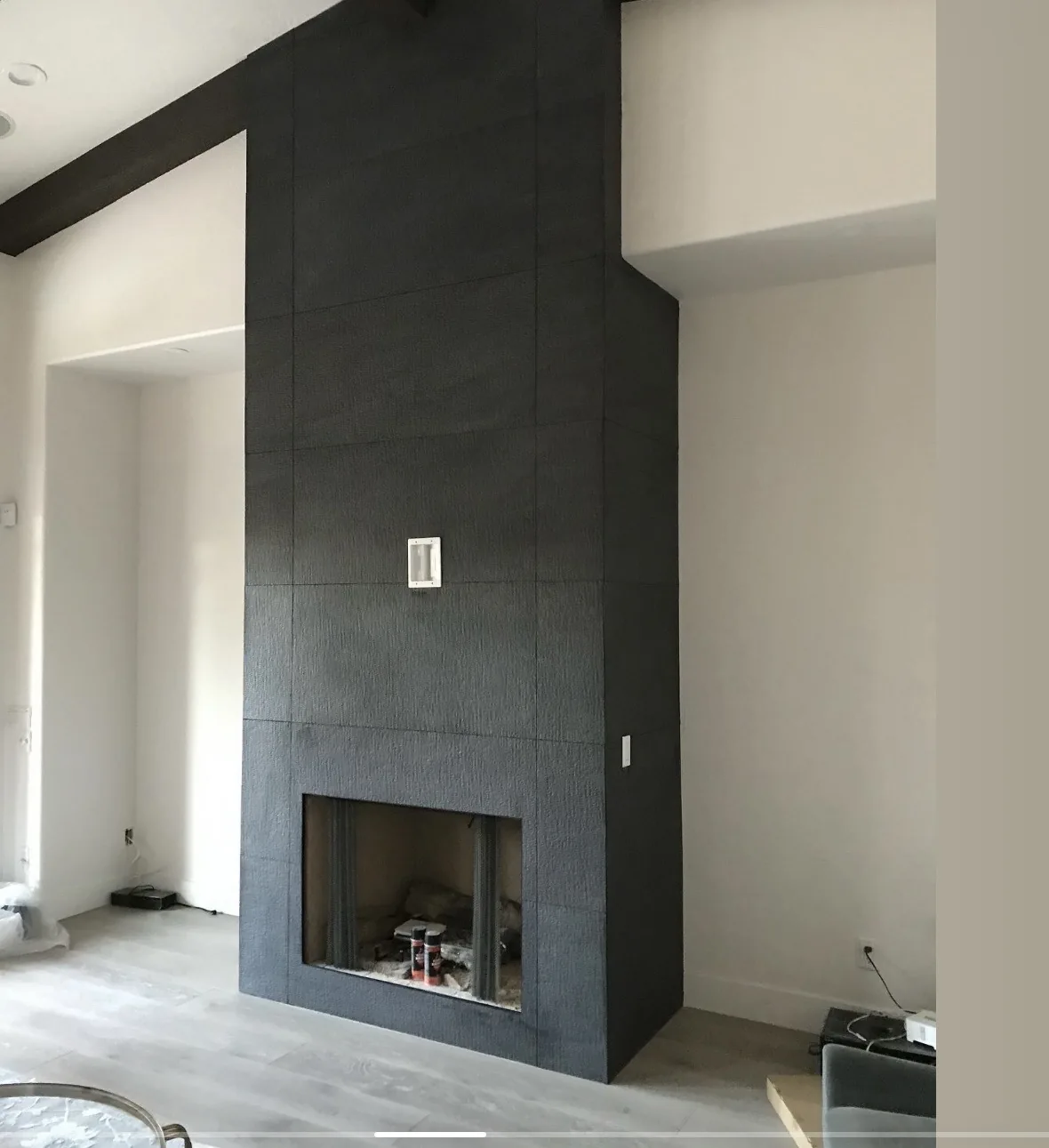 Living room with a dark fireplace wall