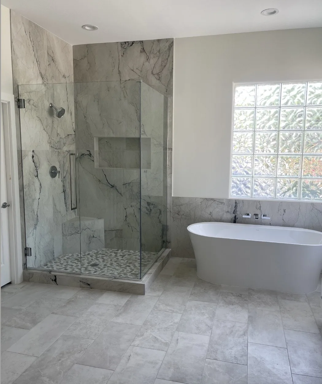 Bathroom with a freestanding tub and tiled shower