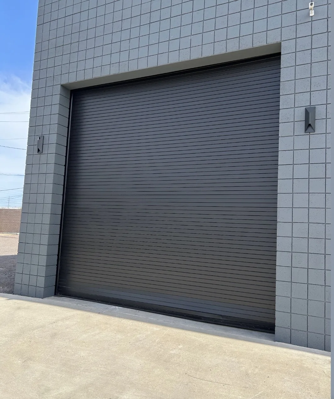 Dark garage door set into a tiled wall