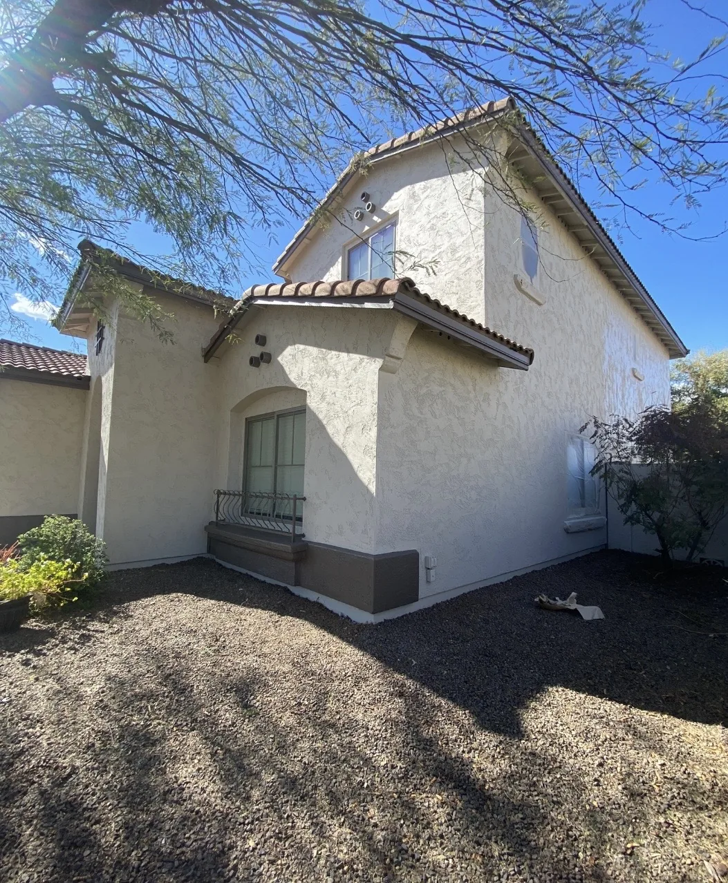 Stucco home with a landscaped side yard