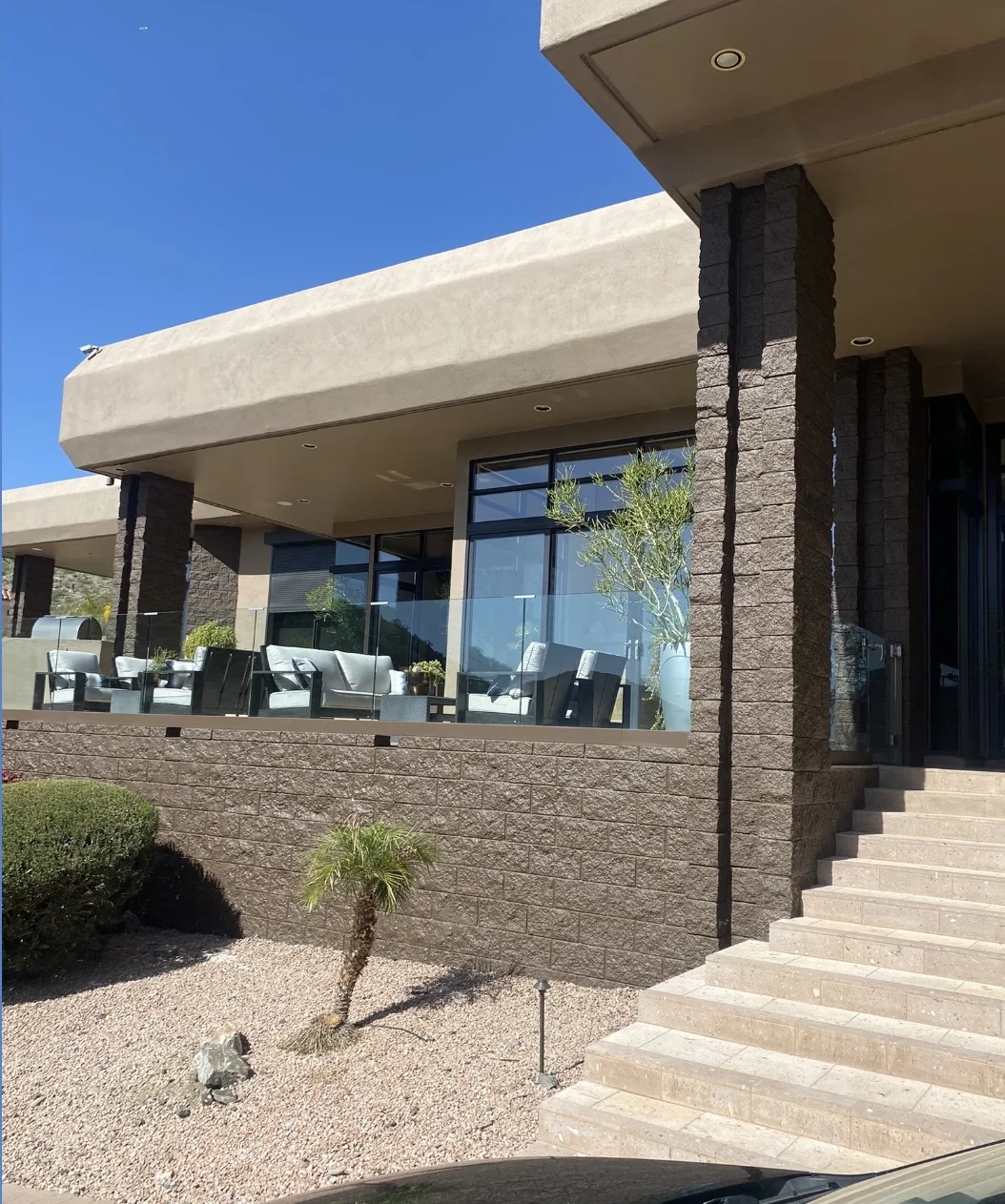 Modern exterior with stucco, stone, and glass windows